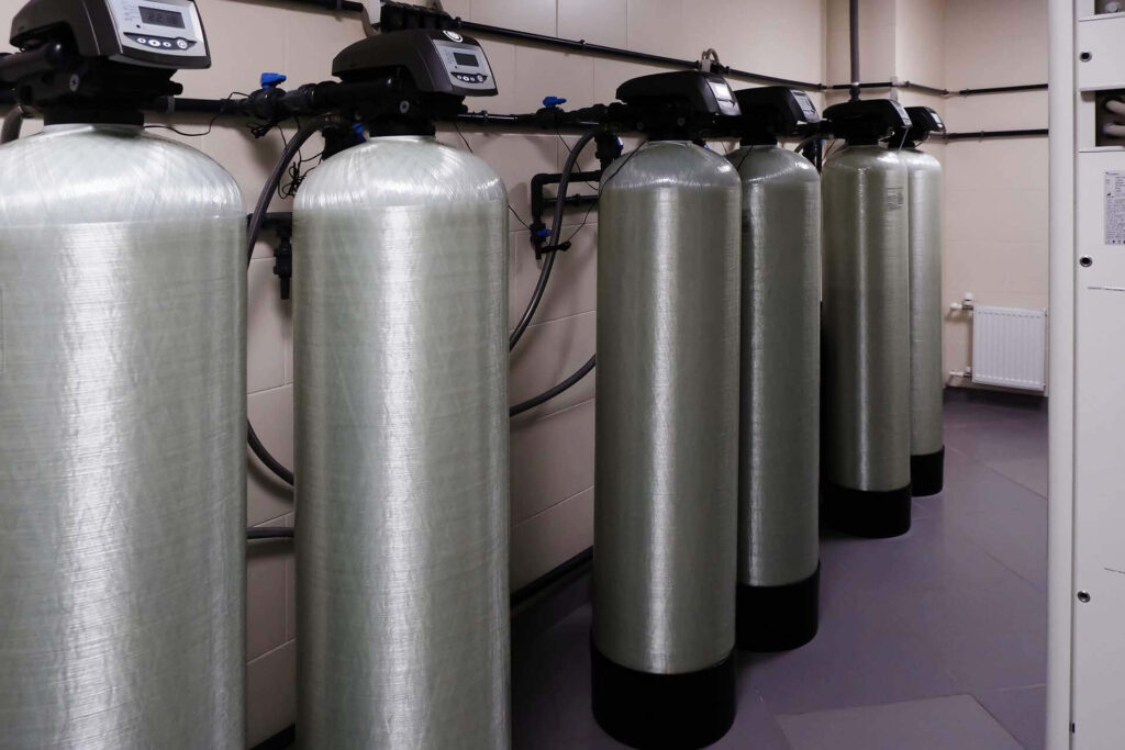 several water softener filters stand in a row