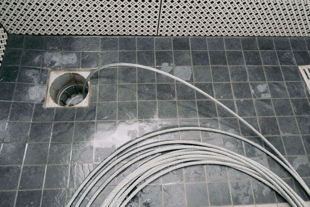 sewer cleaning cable plumber using on drain