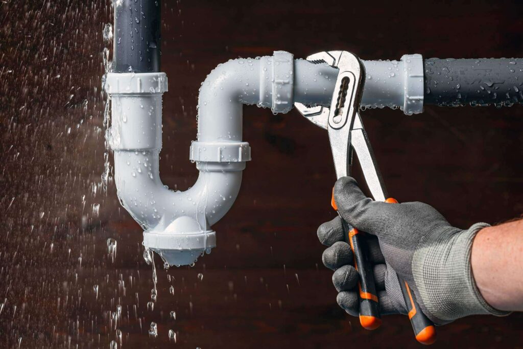 Close plumber fixing water leak